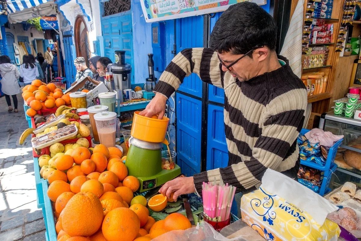 Man squeezing oranges