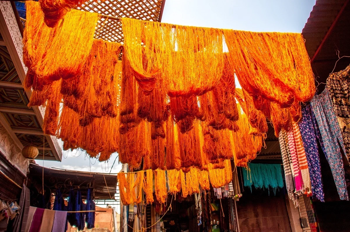 Colored yarn hanging above the dyers' stalls