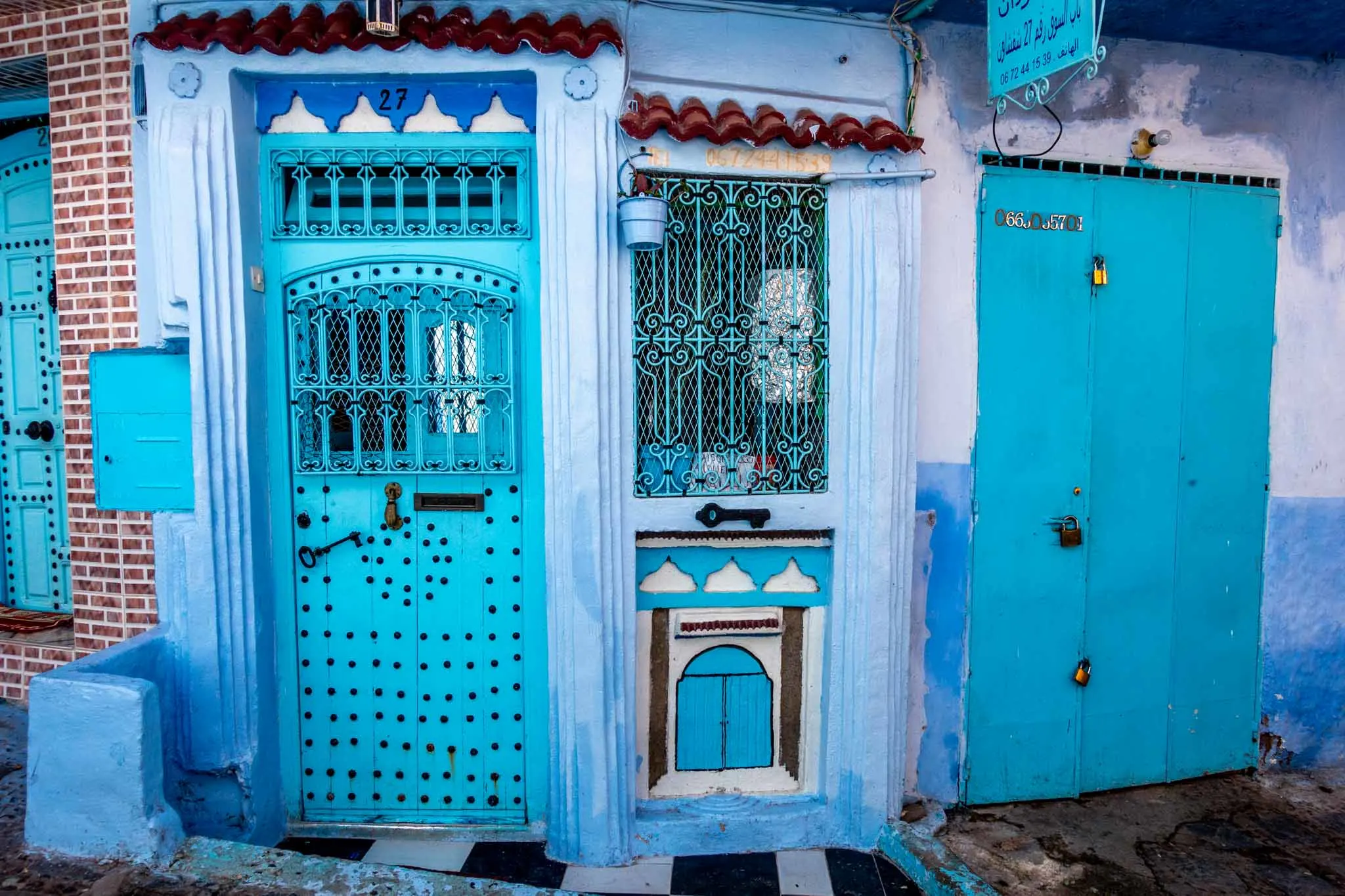 Turquoise doors decorated with turquoise wrought iron